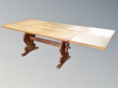An oak extending refectory dining table