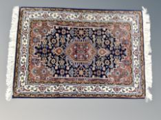 A small fringed Iranian hearth rug 98 cm x 62 cm