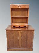 A reproduction yewwood double door cabinet together with a further side cabinet