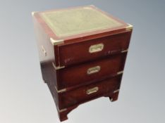A campaign style three drawer chest with leather top width 47 cm