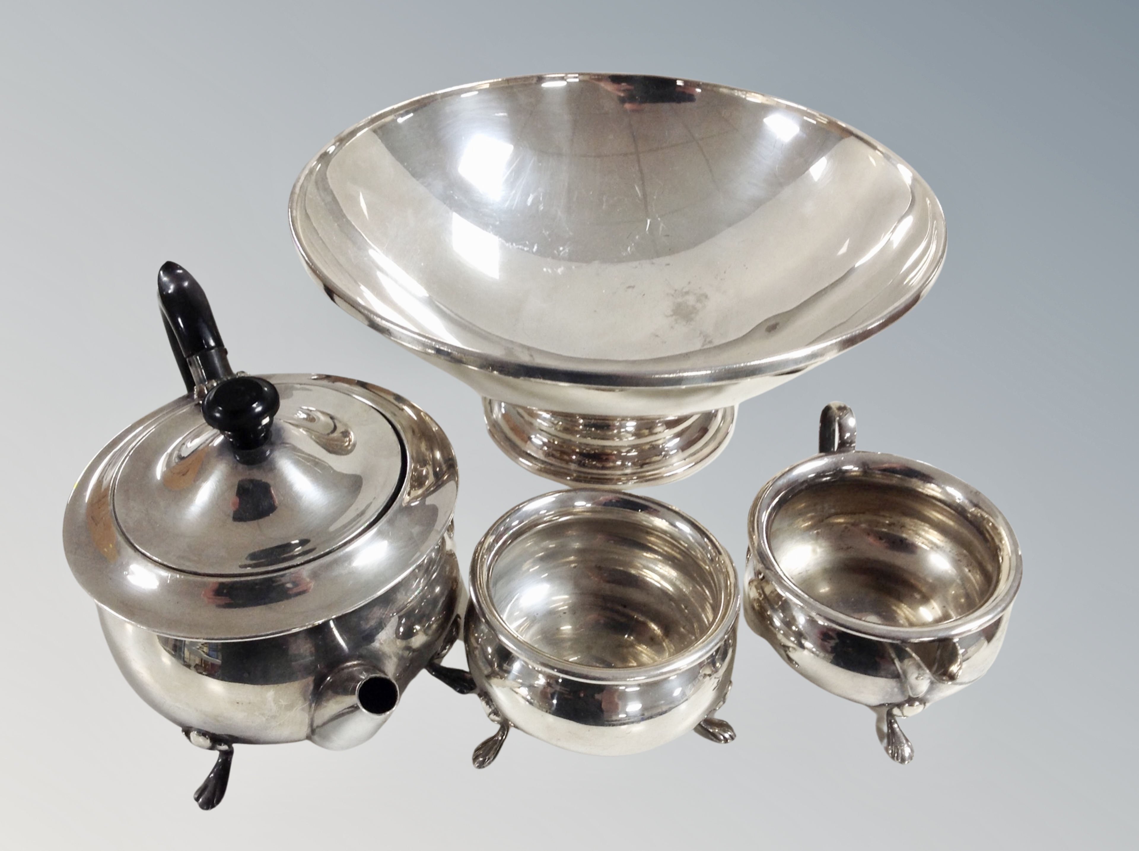 A silver plated pedestal bowl and three piece tea service