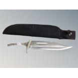 A bowie knife in sheath lacking handle