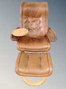 A Scandinavian tan leather swivel armchair with matching footstool