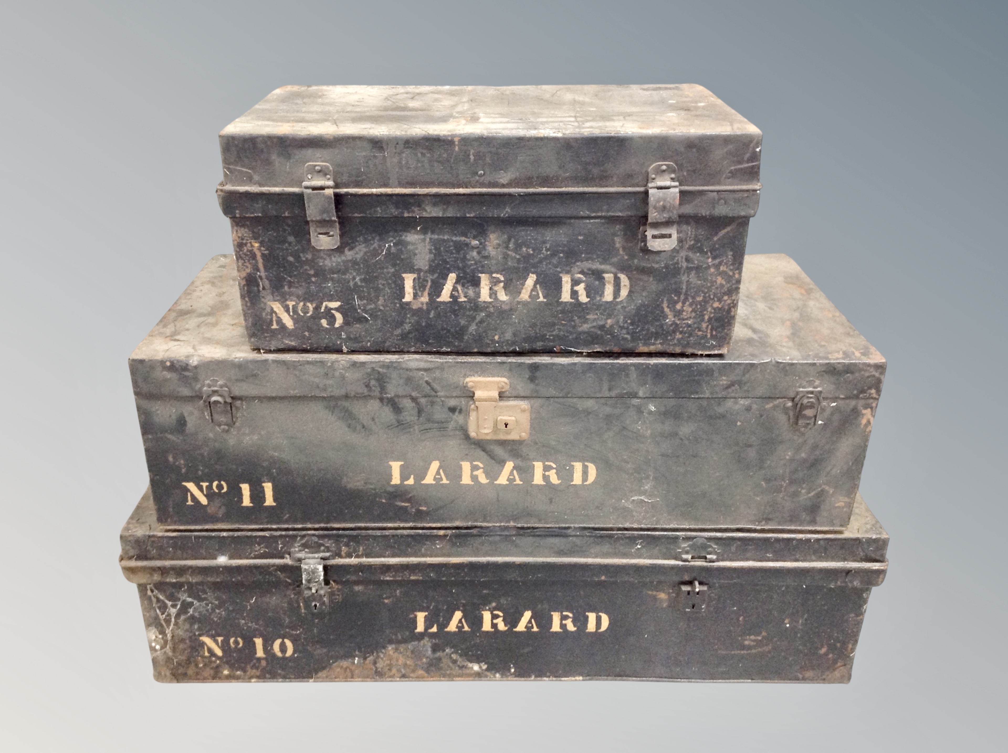 Three lacquered tin trunks