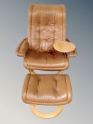 A Scandinavian tan leather swivel armchair with matching footstool