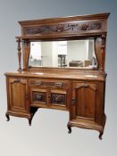 A late Victorian carved walnut mirror backed sideboard,