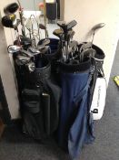 Five golf bags containing irons and drivers ,