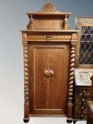 A 19th century oak sentry door cabinet with barley twist supports width 86 cm