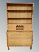 A blonde oak bookcase, fitted drawer beneath,
