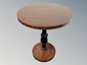 A rosewood effect circular pedestal table