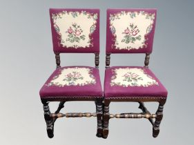 A pair of oak dining chairs in studded upholstery