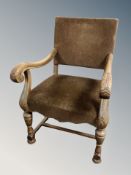 A Continental carved scroll armchair in studded upholstery