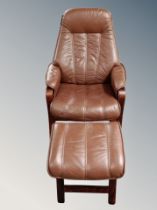 A brown leather beech framed armchair with stool