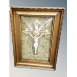 A metal and ceramic crucifix in gilt frame,