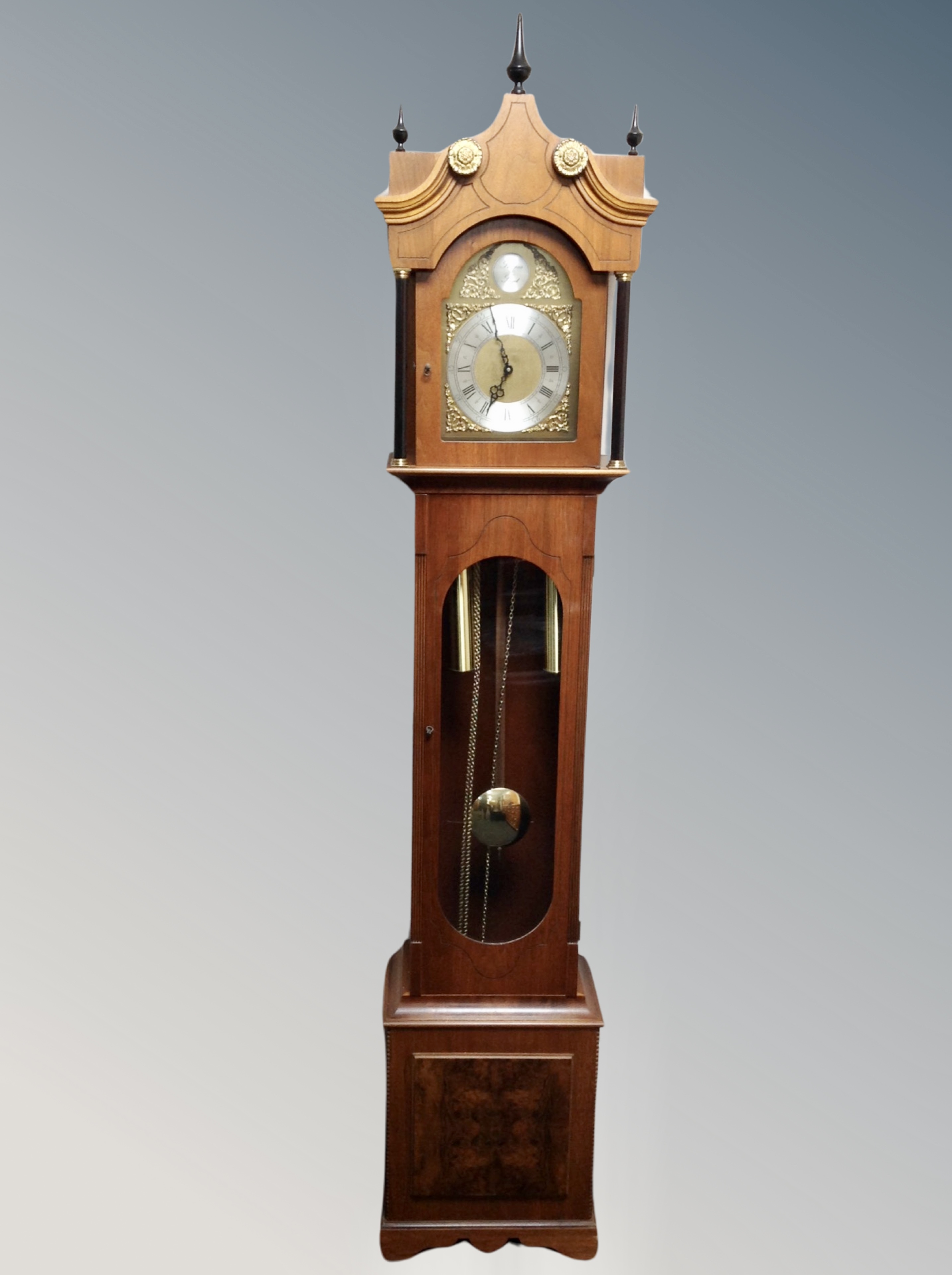 A reproduction Tempus Fugit longcase clock with pendulum and weights