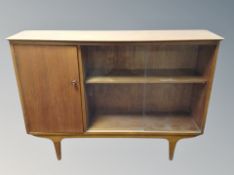 A teak sliding glass door bookcase,