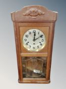 A Continental oak eight day wall clock