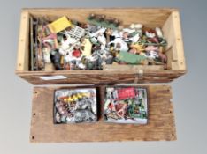 A crate of vintage painted metal and plastic farm animals
