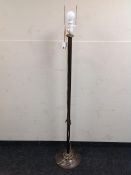 A metal floor lamp with continental wiring