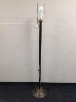 A metal floor lamp with continental wiring