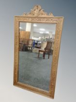 A heavily carved oak mirror 78 cm x 141 cm
