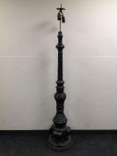 A heavily carved Eastern style standard lamp