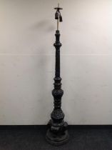 A heavily carved Eastern style standard lamp