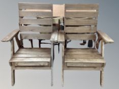 A pair of teak garden armchairs