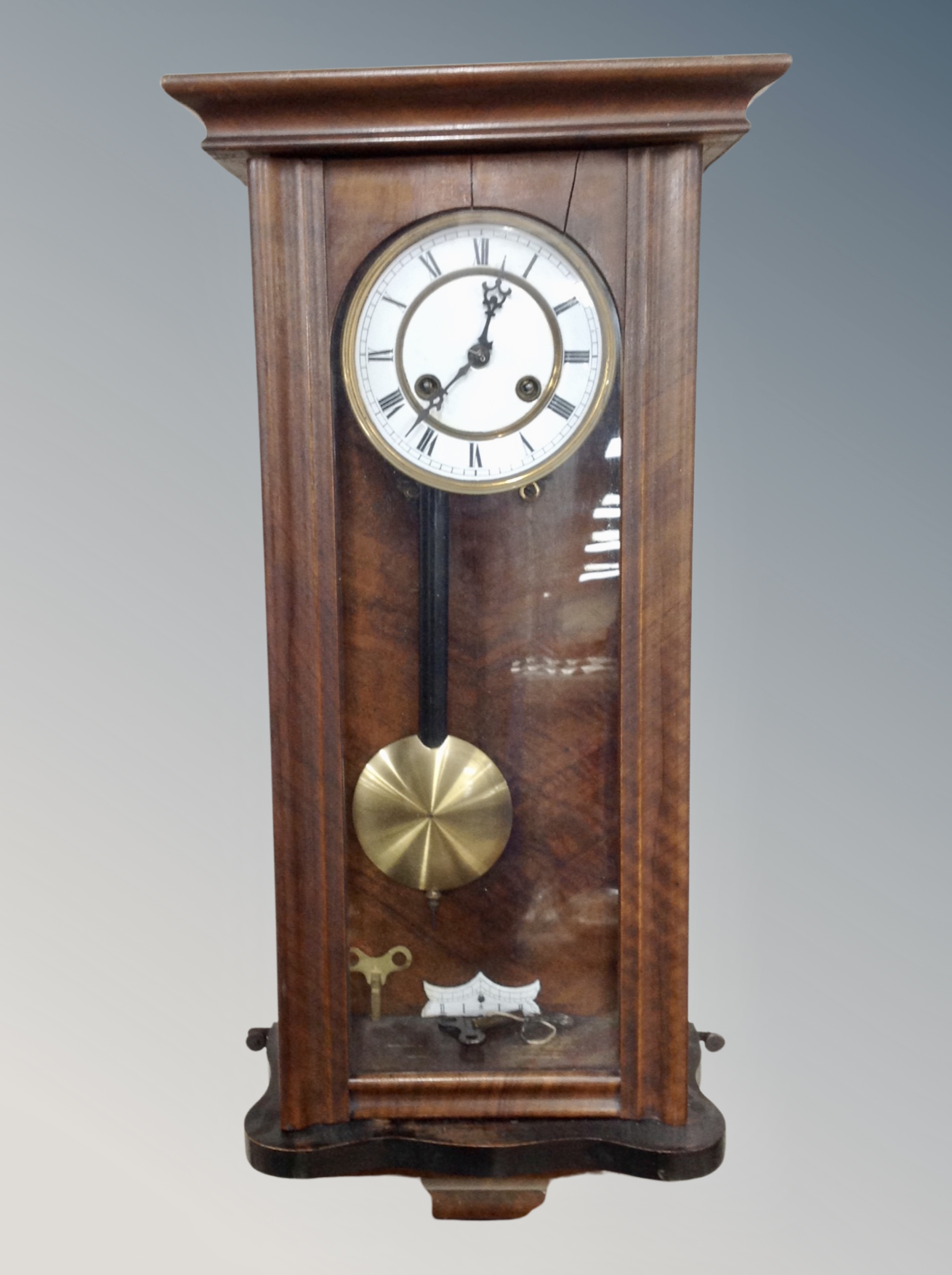 A Continental mahogany eight day wall clock with enamelled dial