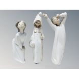 Two Lladro figures of children in nightdress,