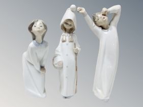 Two Lladro figures of children in nightdress,