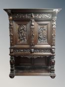 A Continental heavily carved oak court cupboard,