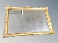 A gilt framed mirror together with a mirrored table lamp
