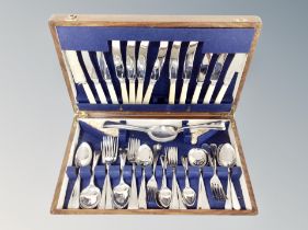 An oak canteen of stainless steel cutlery