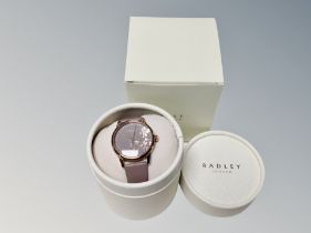 A Lady's Radley quartz wrist watch together with a blue leather Radley purse in cloth carry bag