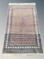 An Iranian fringed rug on lilac ground 174 cm x 95 cm