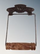 A reproduction cast metal toilet roll holder