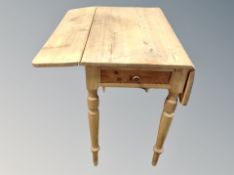 A Victorian pine drop leaf table fitted a drawer