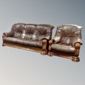 An oak framed brown leather three seater settee and matching armchair