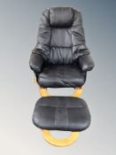 A Scandinavian blacl leather swivel armchair with matching footstool