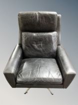 A Danish black leather and chrome swivel armchair
