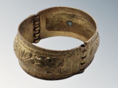 An ornate gilded bangle