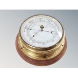 A brass circular barometer