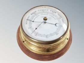 A brass circular barometer