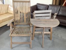 Two teak garden armchairs and a table