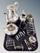 A silver plated three piece tea service, three toast racks, knife rests,