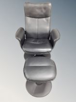 A black leather upholstered swivel armchair and footstool