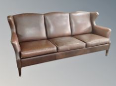A Danish brown leather three seater wing backed settee length 197 cm