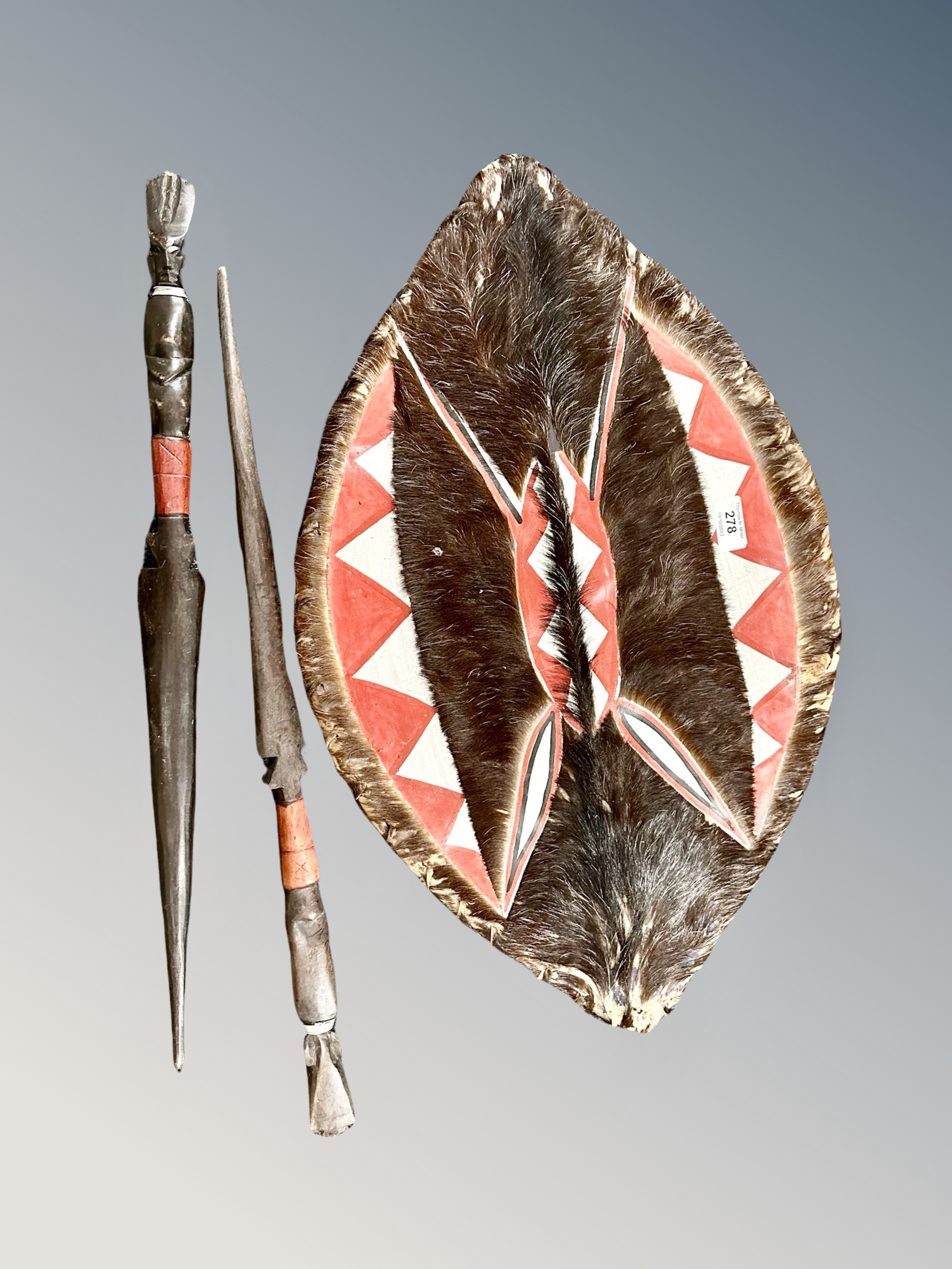 A tribal shield and two wooden spears