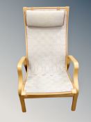 A Scandinavian beech framed armchair with canvas seat